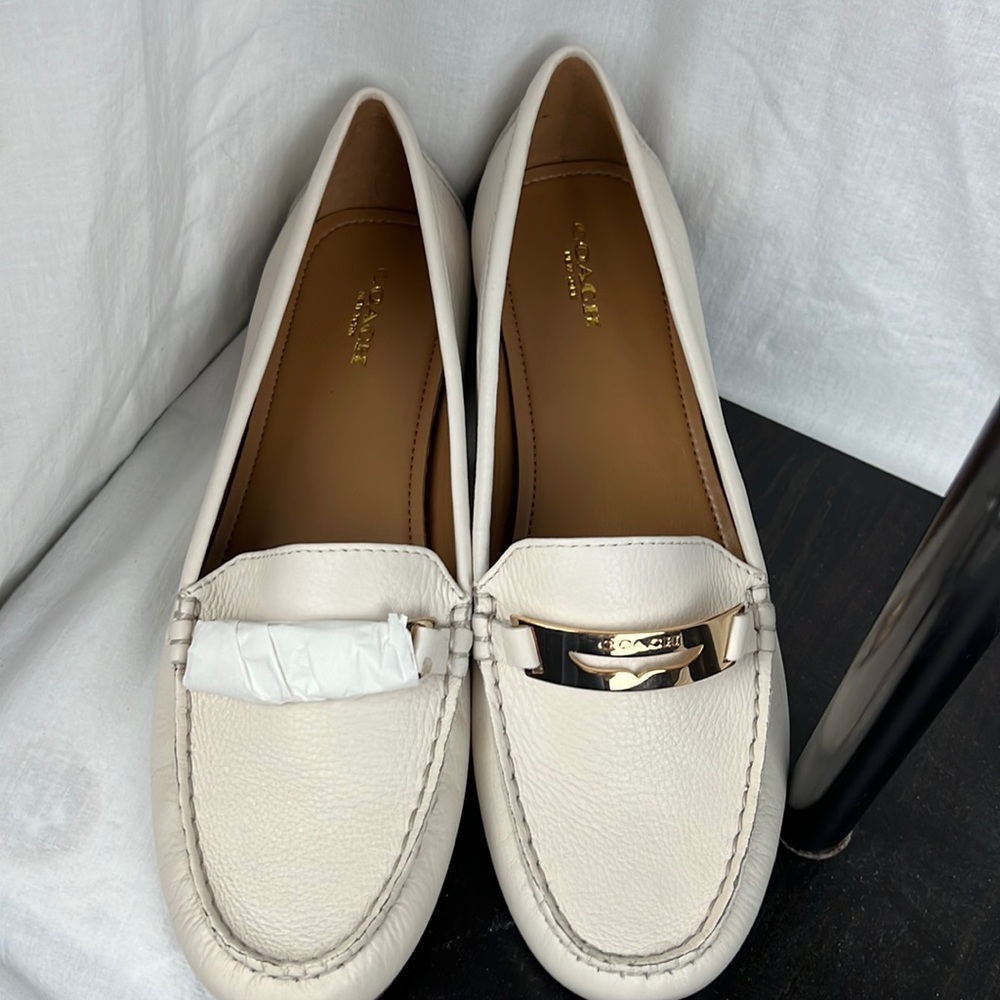 Women’s size 10M ivory with gold trim COACH shoes. New in box.